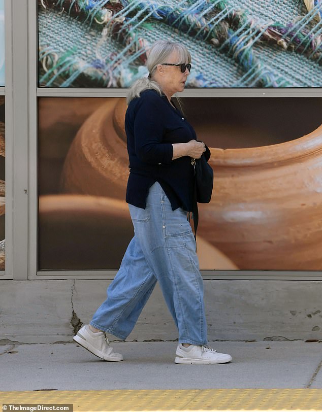 For accessories, she went with a pair of black sunglasses, a black sling bag with tan lining and kept her sleek white hair in a ponytail
