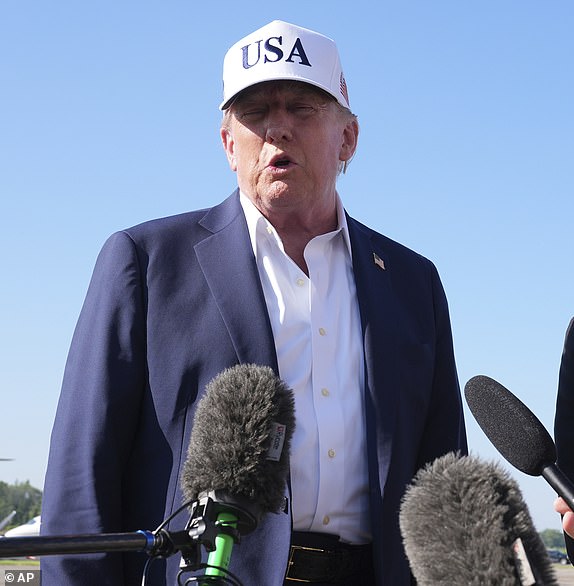 President Donald Trump, left, speaks with reporters as Commerce Secretary Howard Lutnick listens before boarding Air Force One at Morristown Municipal Airport in Morristown, N.J., Sunday, July 6, 2025, en route to Washington. (AP Photo/Jacquelyn Martin)