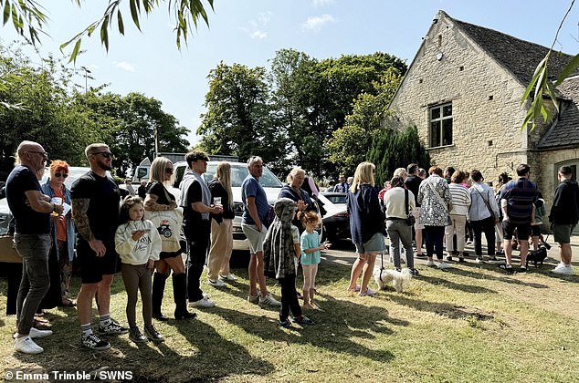 Customers are seen queuing up outside The Farmer's Dog pub as it opened last August