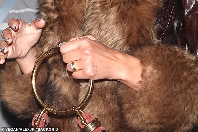Dua appeared in great spirits and flashed a huge smile as well as her £25K engagement ring, following Callum Turner's romantic Christmas proposal
