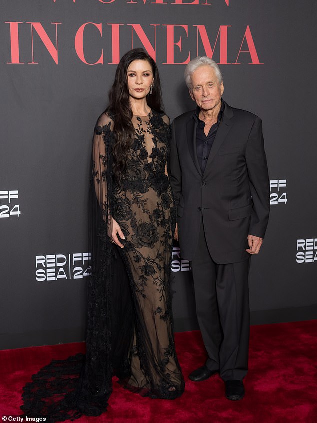 He said that he is 'happy to play the wife' to his wife of nearly 25 years, Catherine Zeta-Jones, 'in the spirit of maintaining a good marriage; pictured December 2024 in Jeddah
