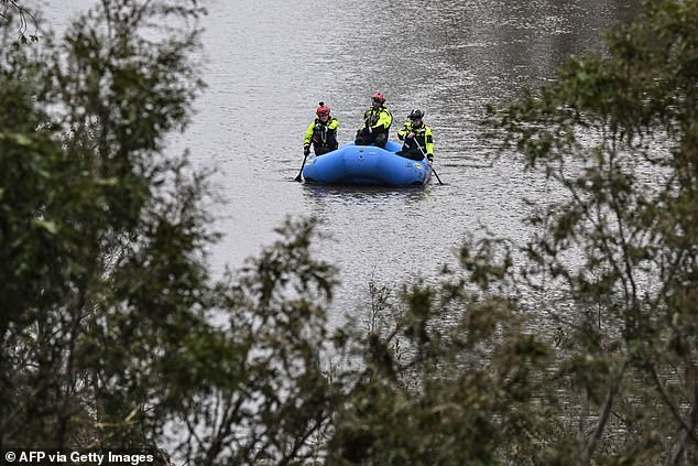 Members of a rescue team look for missing people on the Guadalupe River