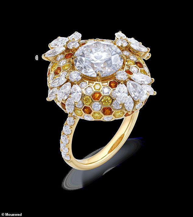 The result is a dazzling 18K yellow gold ring adorned with both white and yellow diamonds, as well as citrine accents