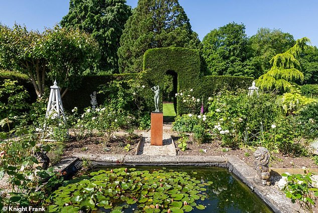 Exceptional: Rose Cottage's owner has a little help tending to the garden
