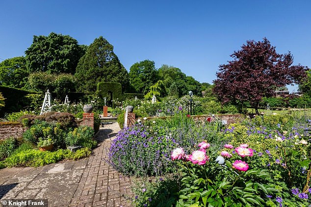 Delightful: It has a glorious, established formal English cottage garden
