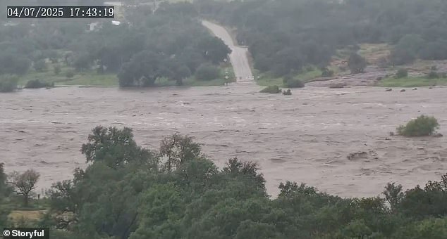 After the full hour has passed, only two tree tops are left visible as the flood water surges through the area