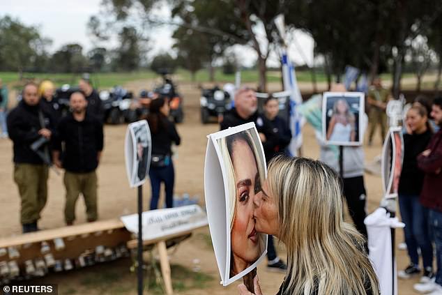 A woman kisses a picture of Mercedes Oria Amar who was killed at the Nova festival when Hamas launched its deadly assault on the venue on October 7