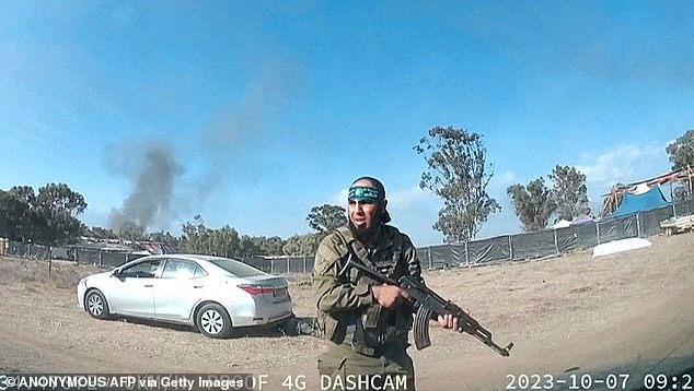 Pictured is footage of an Hamas extremist, armed with an assault rifle, during the Oct 7 attacks