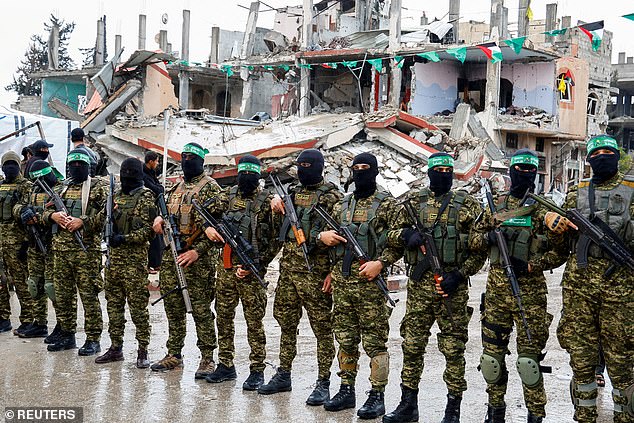 Hamas militants stand guard on the February 22, 2025 - day of the handover of hostages held in Gaza since the deadly October 7