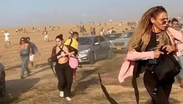 Pictured is a photo showing people fleeing from the Nova Music Festival during Hamas' murderous assault on the venue on October 7, 2023