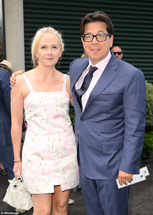 She accessorised with pastel heels and a matching handbag as she posed with her husband before taking their seats in the stand