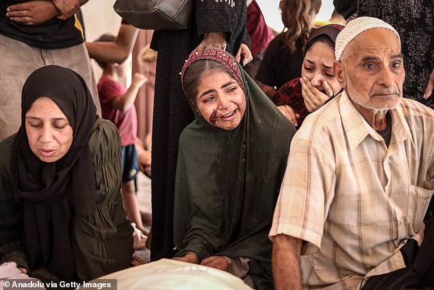 Relatives mourn their loss as the bodies are transferred to al-Ahli Baptist Hospital for funeral procedures before burial, after the Israeli attack on the Zaytun neighborhood in eastern Gaza, on July 5, 2025