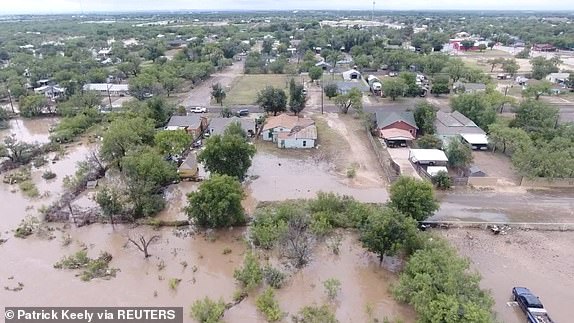 A drone view shows houses flooded following torrential rains that unleashed flash floods along the Concho River in San Angelo, Texas, U.S., July 4, 2025, in this screen grab obtained from a social media video. Patrick Keely/via REUTERS  THIS IMAGE HAS BEEN SUPPLIED BY A THIRD PARTY. MANDATORY CREDIT. NO RESALES. NO ARCHIVES. REFILE - CORRECTING NAME OF RIVER FROM "GUADALUPE" TO "CONCHO" AND MONTH FROM "JUNE" TO "JULY".