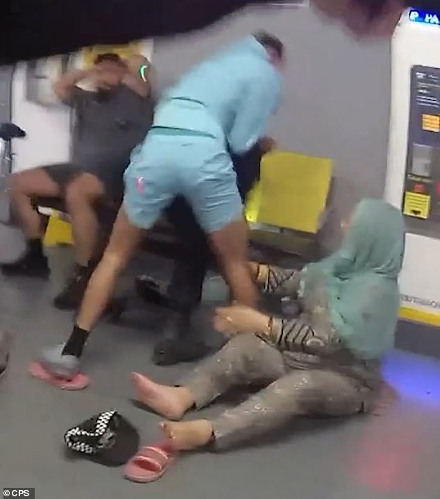 Pictured is the moment Amaaz appears to lash out at one of the officers hitting them