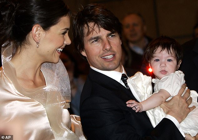 The couple are pictured with their daughter Suri in 2006