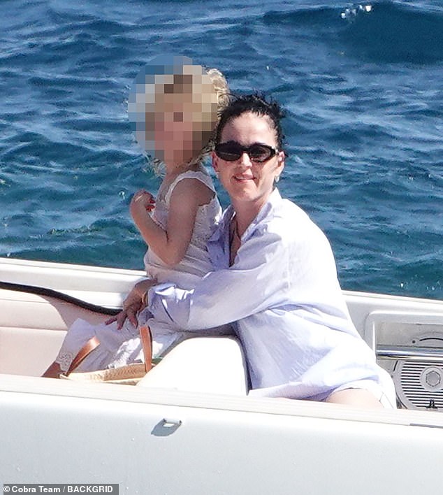 Katy cuddled up to her daughter
