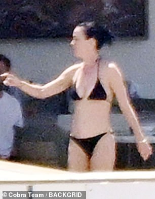 Katy tied her signature raven-colored locks in a ponytail