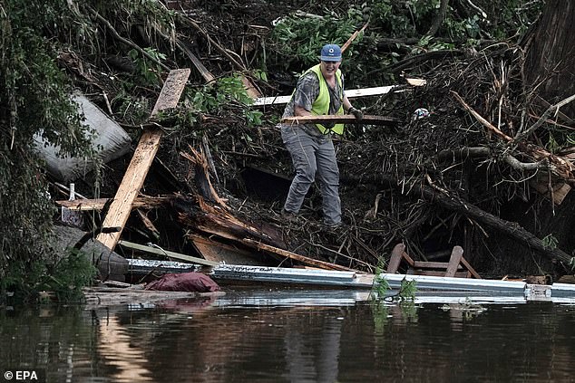 Search teams look through vegetation and debris along the Guadalupe River in Hunt, Texas on Sunday, July 6, 2025