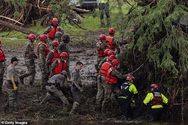 Search and recovery workers dig through debris looking for any survivors or remains of people swept up in the flash flooding at Camp Mystic on July 6, 2025 in Hunt, Texas