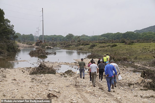Volunteers were seen walking onto a flooded area in the aftermath to search for survivors in Ingram