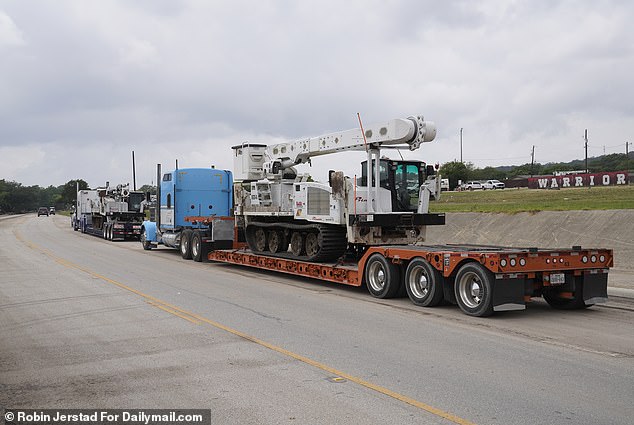Police cars and big rigs hauling specialist gear, such as air boats and cherry pickers equipped with tracks, were seen on the TX-39 highway which cuts through town as recovery operations got underway