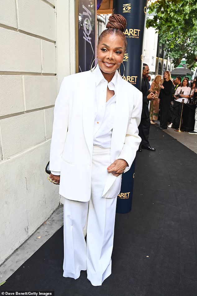 Janet cut a stylish figure in a chic white trouser suit and a matching shirt as she posed for snaps at the event