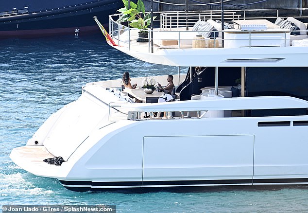 A shirtless Ronaldo soaks up the rays in sunny Spain while Georgina watches on
