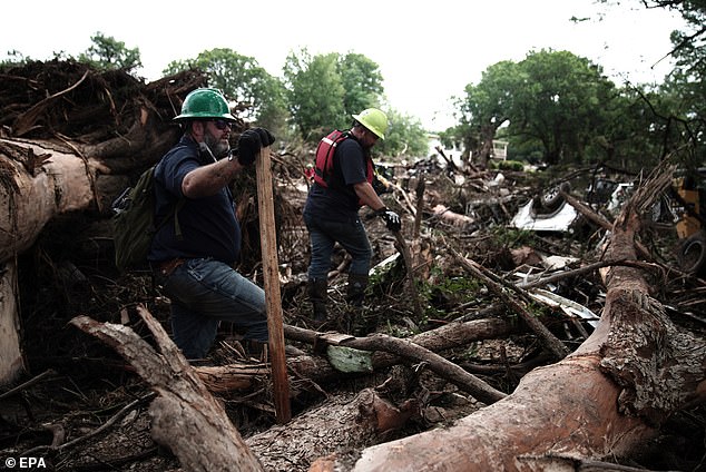 Pictured: First responders search an area along the Guadalupe river near Blue Oak RV Park in Hunt, Texas, today