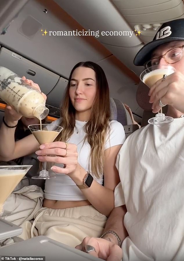 Recording herself and her partner sitting in their seats with their table trays pulled down, the flight attendant produced a plastic cocktail mixing glass from her bag and a cup of ice that had she had requested from cabin crew