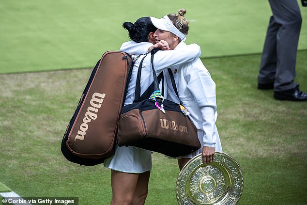 Hugs all round: 15. Vondrousova of the Czech Republic, still holding the winners trophy, hugs a tearful Jabeur of Tunisia as she leaves the court