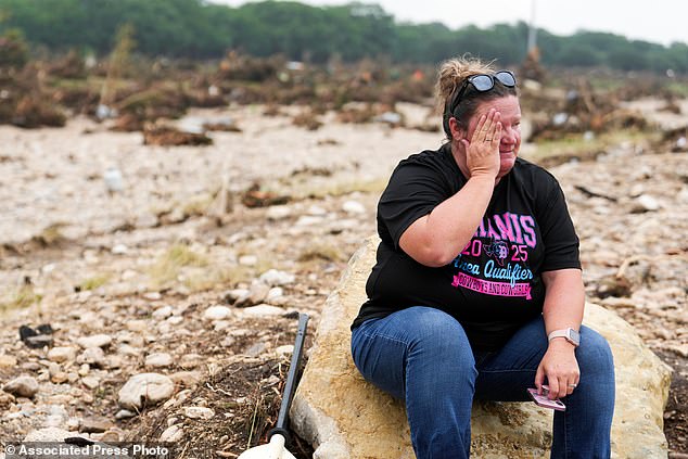 Marissa Zachry takes a moment while searching for survivors along the Guadalupe River