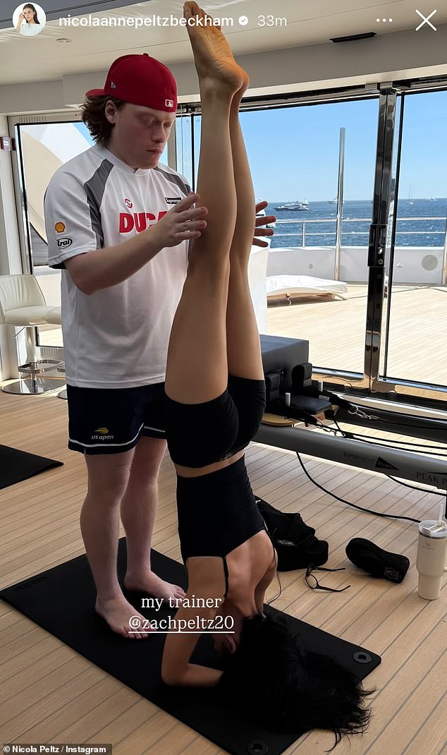 On Monday, Nicola shared a snap of herself performing a headstand while her younger brother Zachary - who she joked was 'her trainer - held her legs up