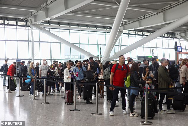 Passengers queue to enter airport security at London Heathrow Terminal Five in April 2022