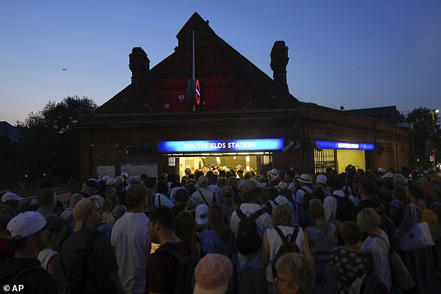 People queue to enter Southfields London Underground station last week