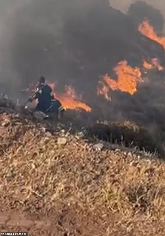 Another series of photos taken by emergency services showed brave firefighters getting within just a few feet of growing flames and showering them with water