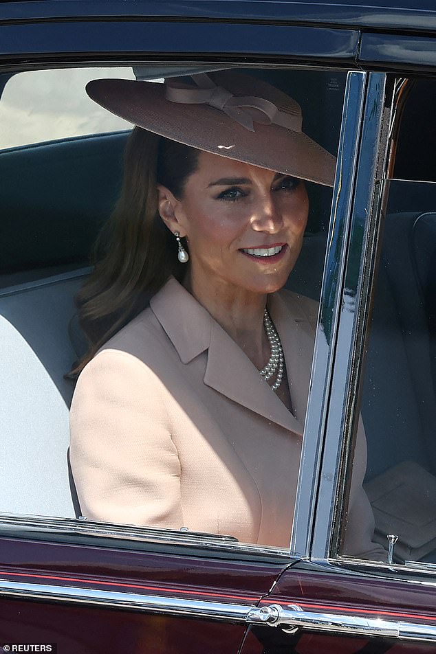 Catherine, Princess of Wales, sits in a car as she leaves after welcoming France's President Emmanuel Macron and his wife