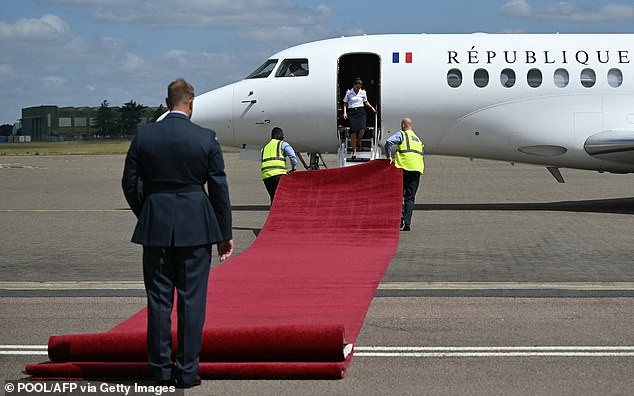 Ground staff roll out a red carpet for Emmanuel and Brigitte Macron at RAF Northolt today