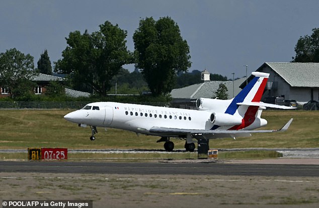 An aircraft carrying Emmanuel and Brigitte Macron lands at RAF Northolt in West London today