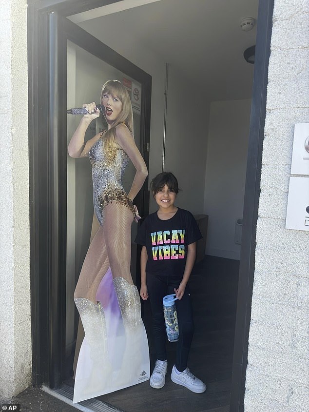 Alice da Silva Aguiar, nine, with a cardboard cutout of her pop hero before the fatal attack