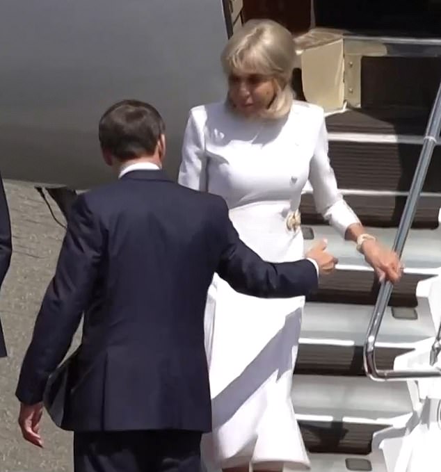 Brigitte did not accept her husband's offer of a helping hand as she walked down the steps on Tuesday