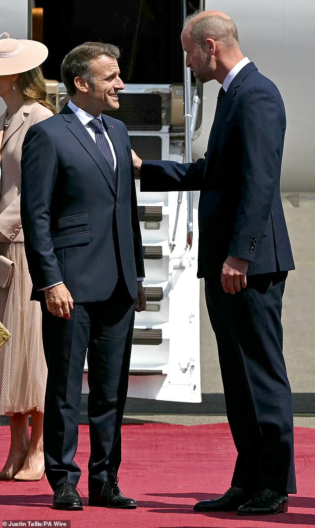French President Emmanuel Macron smiled as he was welcomed by the Prince of Wales at RAF Northolt today