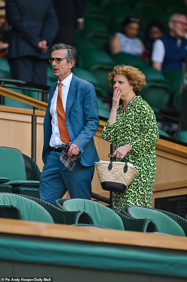 Ms Flind wore an abstract printed green dress and carried a raffia bag with contrast black straps as she was joined by Robert Peston on centre court at SW19