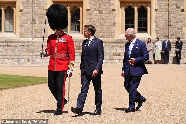 Emmanuel Macron and King Charles III inspect the Guard of Honour at Windsor Castle today