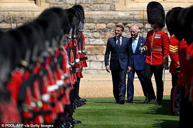 Emmanuel Macron and King Charles III inspect the Guard of Honour at Windsor Castle today