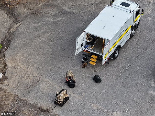 Pictured is a member of the military bomb squad unit called in to the incident last night