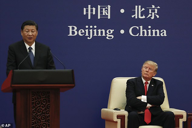 US President Donald Trump listens to a speech by Chinese President Xi Jinping during a business event at the Great Hall of the People in Beijing, Thursday, Nov. 9, 2017. In February, Trump signed a national security memorandum to restrict Chinese purchases of US land