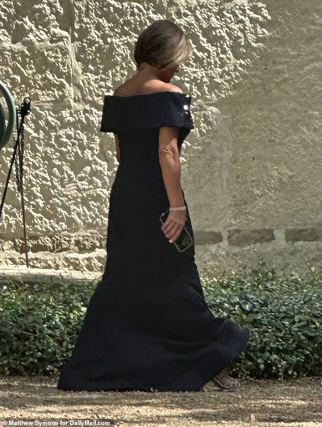 At Emma's wedding, Retton wore an over-the-shoulder sparkly midnight blue dress paired with a silver bracelet and high heels
