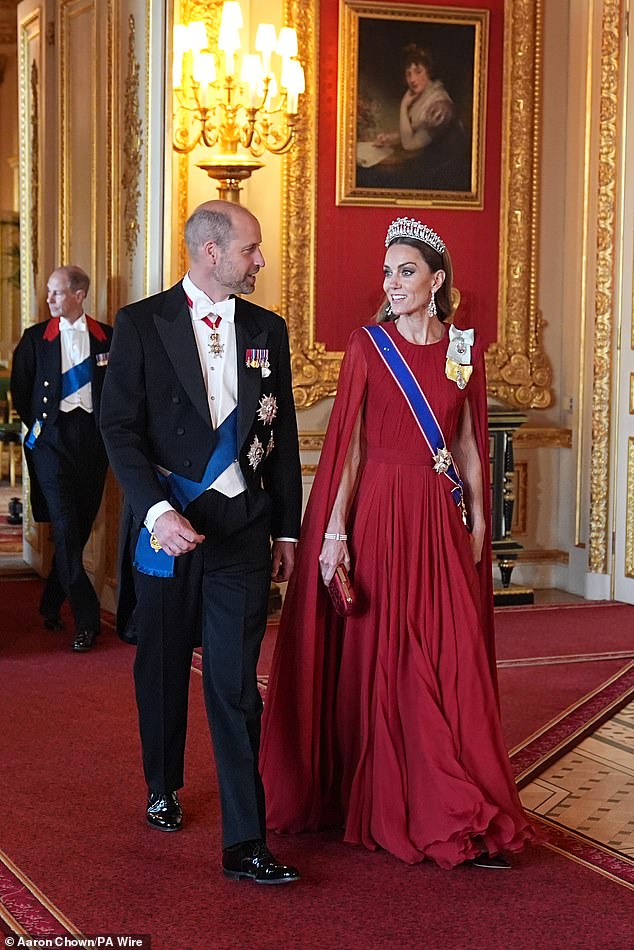 Kate was a vision in scarlet, as she sported a gown with caped back detailing, designed by Sarah Burton for Givenchy. It is worn with a Lily of the Valley embroidered evening clutch