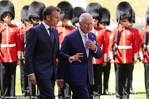 Emmanuel Macron and King Charles III inspect the Guard of Honour at Windsor Castle today