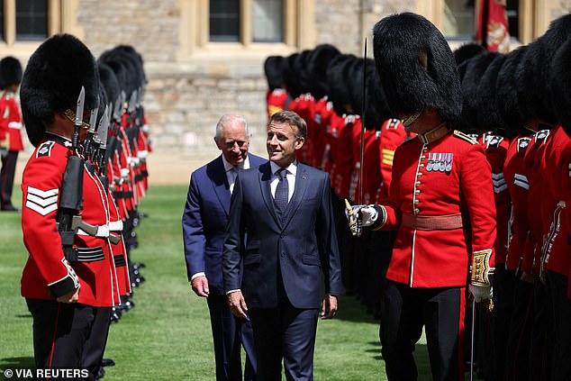 Emmanuel Macron and King Charles III inspect the Guard of Honour at Windsor Castle today